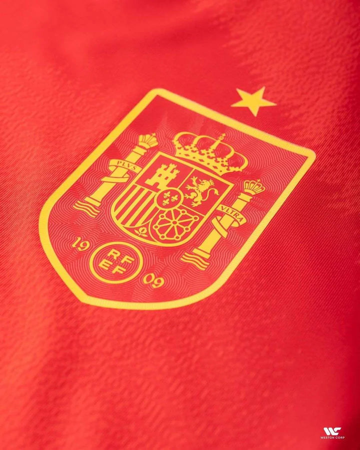 Close-up of the crest on the 2024-25 Spain player version jersey showcasing the national emblem