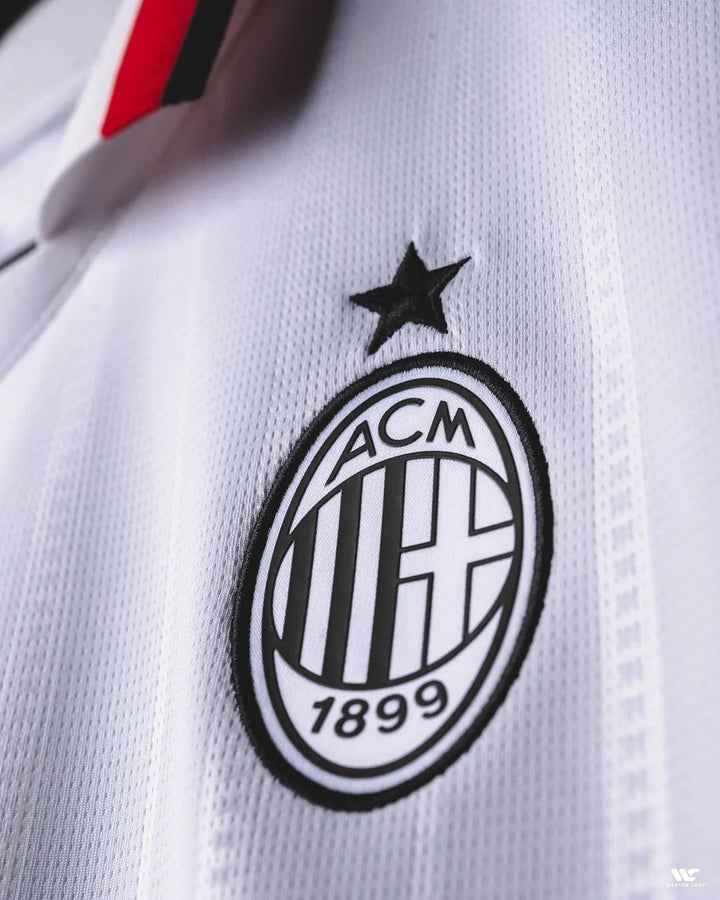 Close-up of the AC Milan away jersey 2024-25 logo featuring the iconic club crest