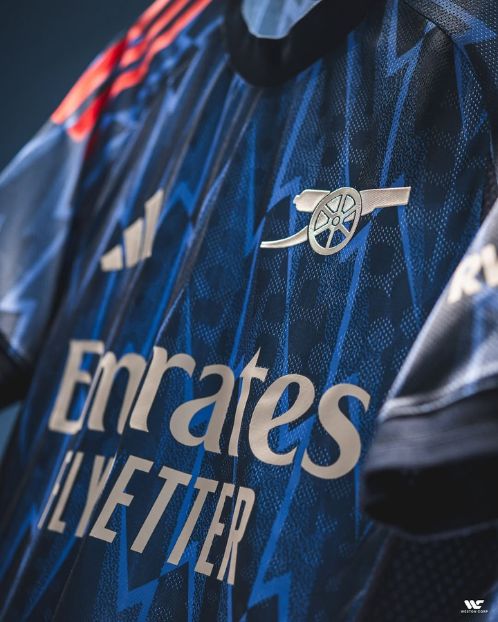 Striker Store close up of Arsenal away jersey 2025-26 navy patterned shirt with Emirates sponsor and cannon crest