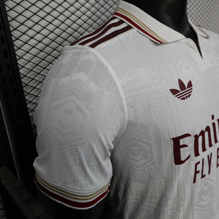 Striker Store Arsenal 2025 26 third jersey white with maroon and gold details on sleeve and collar
