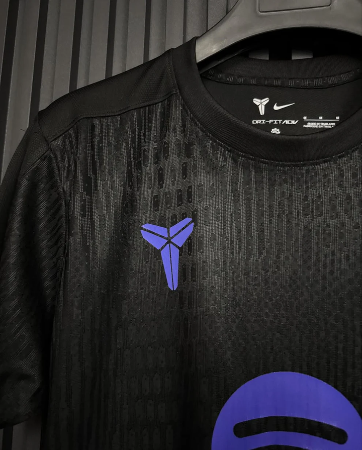 Close-up of FC Barcelona Kobe Bryant pre match jersey featuring black fabric and purple accents