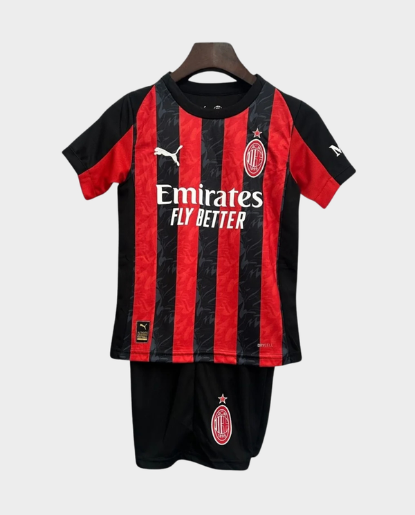 Kids AC Milan home kit 2025-26 featuring iconic red and black stripes with Emirates logo