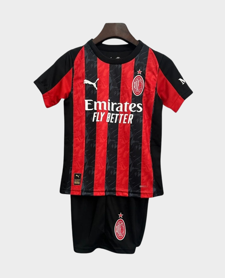 Kids AC Milan home kit 2025-26 featuring iconic red and black stripes with Emirates logo