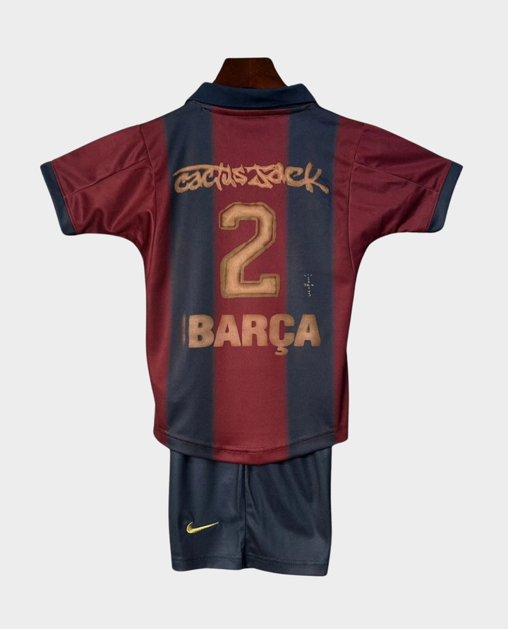 Kids Barca Travis Scott retro kit featuring a red and blue jersey with matching shorts