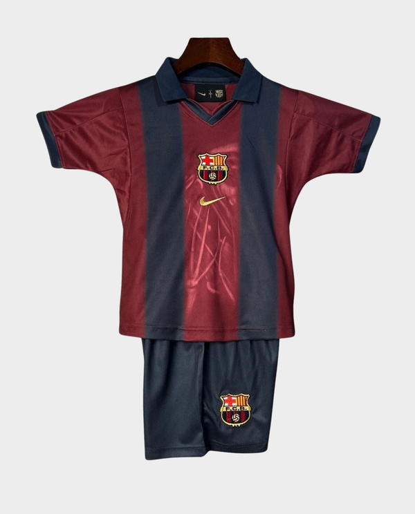 Kids Barca Travis Scott retro kit featuring a classic red and blue jersey with matching shorts