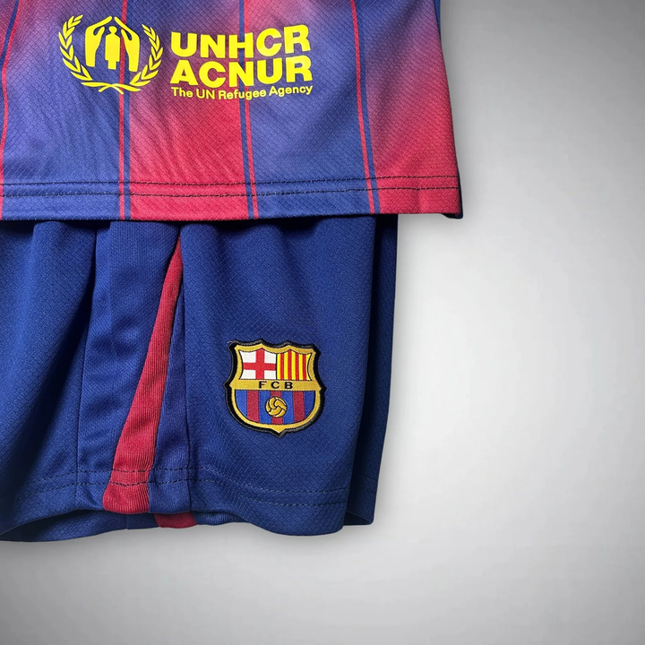 Kids Barcelona Home Kit 2025-26 featuring red and blue jersey and shorts with club logos
