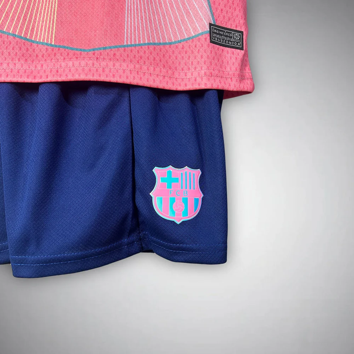 Kids FC Barcelona Pink Jersey 2025-26 featuring vibrant colors and club emblem on shorts