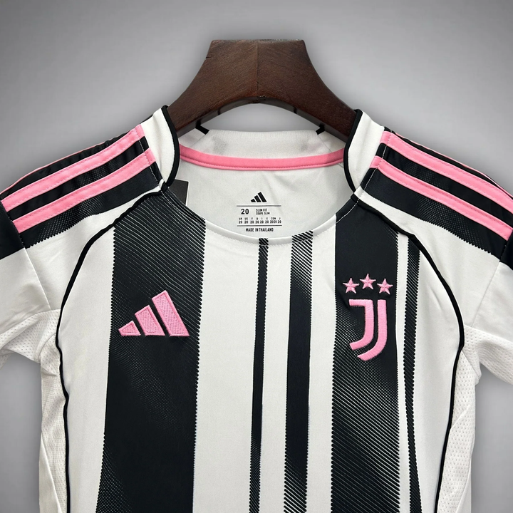 Kids Juventus home kit 2025 featuring black and white stripes with pink accents