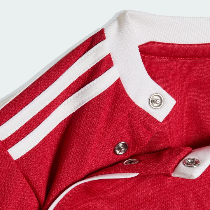 Close-up of Kids Liverpool home kit 2025-26 featuring red fabric and white stripes on the collar