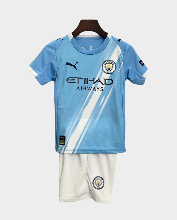 Kids Manchester City home kit 2025 featuring light blue shirt and white shorts for young fans