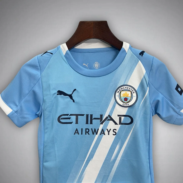 Kids Manchester City home kit 2025 in sky blue with team logo and sponsor branding
