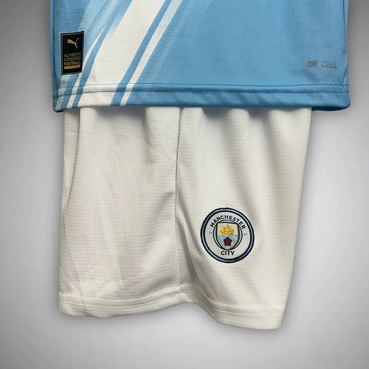 Kids Manchester City home kit 2025 with light blue jersey and white shorts for young fans