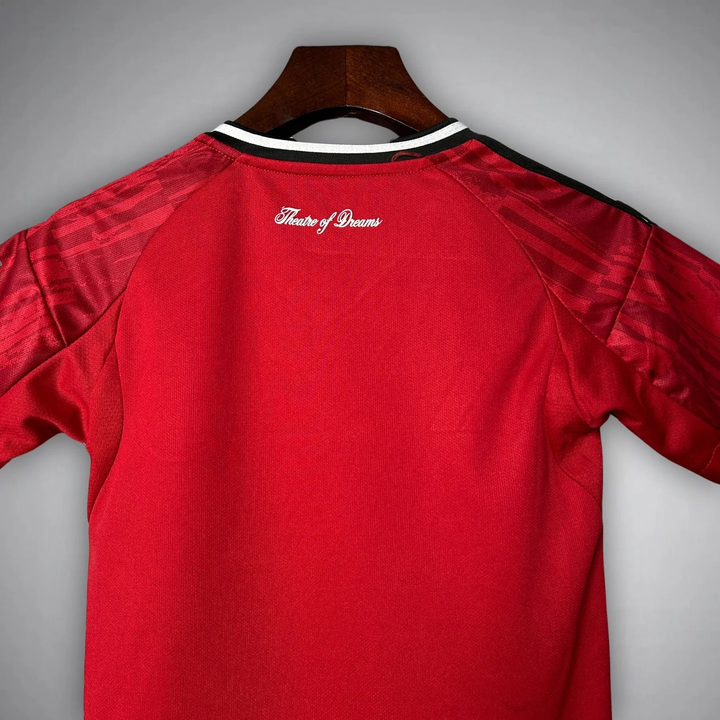 Back view of Kids Manchester United 2025-26 home kit showcasing vibrant red design and detailed fabric