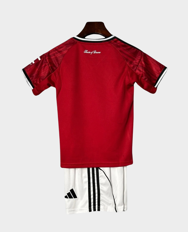 Kids Manchester United 2025-26 home kit featuring a red jersey and white shorts for young fans