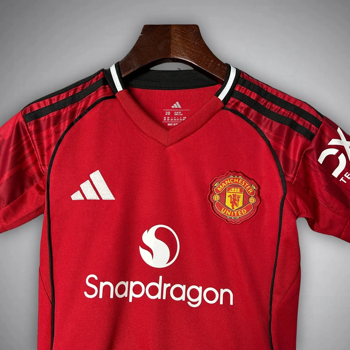 Kids Manchester United 2025-26 home kit featuring red jersey with logo and black accents