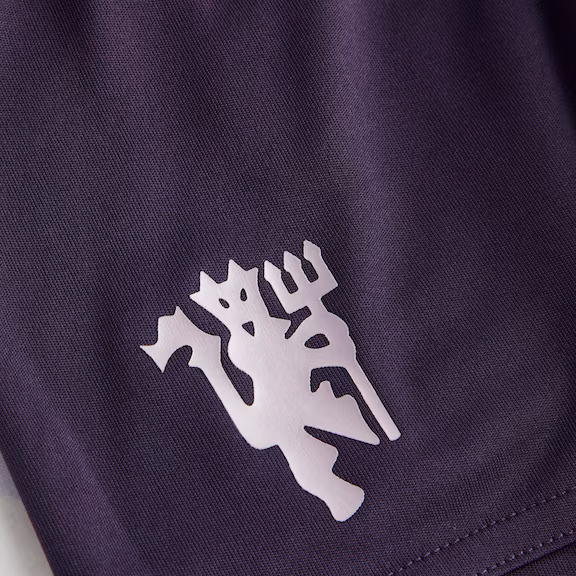 Kids Manchester United Away Kit 2025-26 featuring the iconic club logo on the shorts