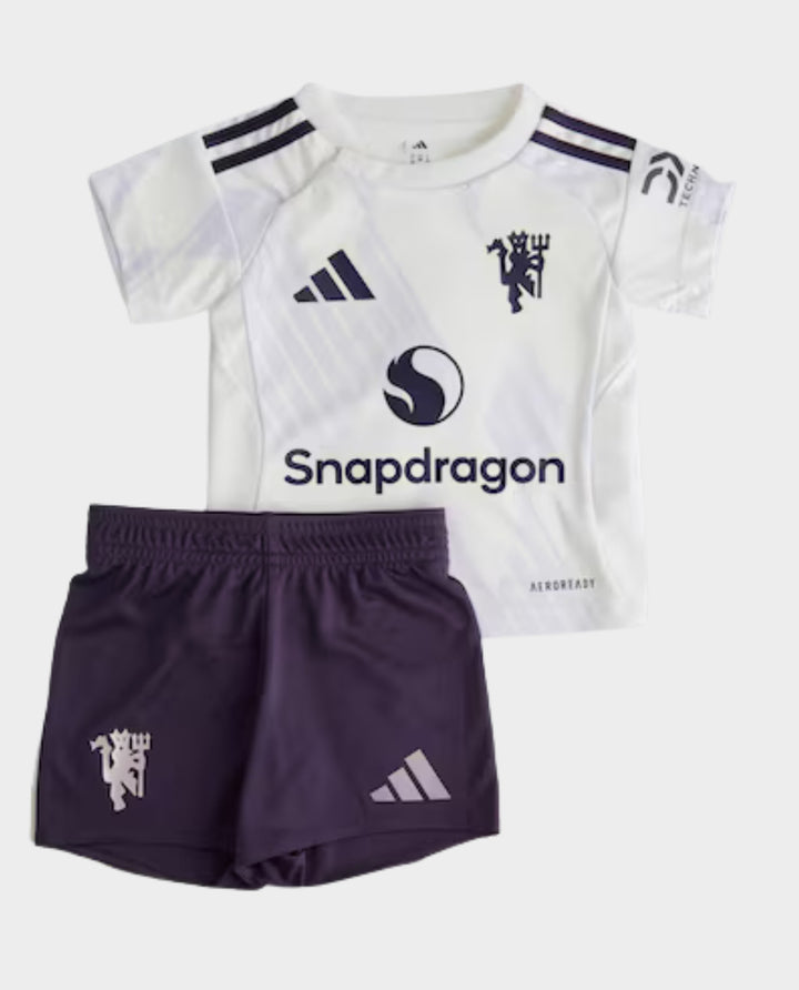 Kids Manchester United Away Kit 2025-26 featuring a white jersey and purple shorts for young fans