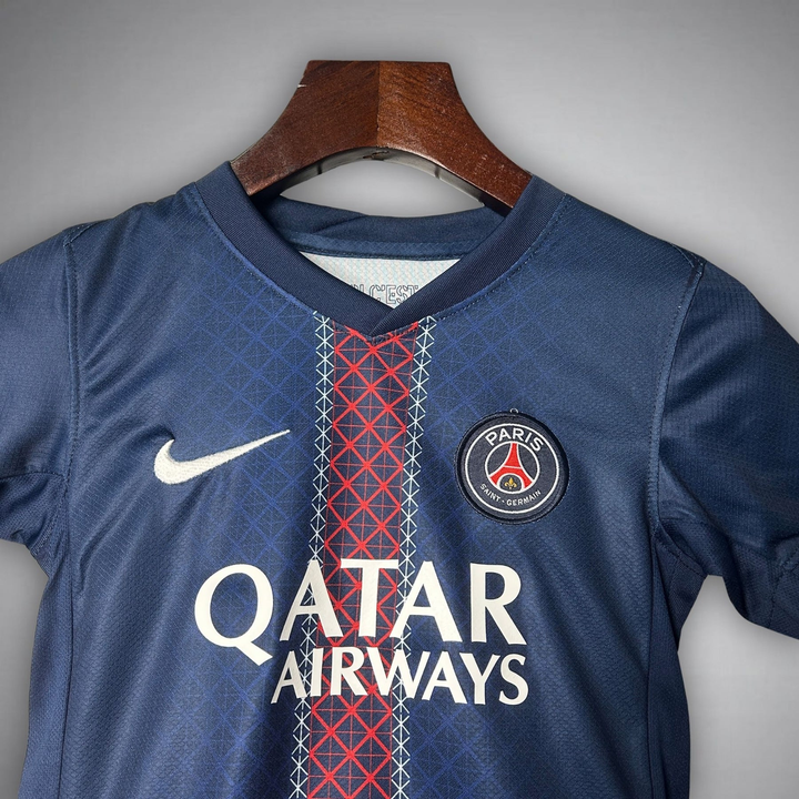 Kids PSG home kit 2025-26 featuring Nike logo and Qatar Airways sponsorship in navy blue