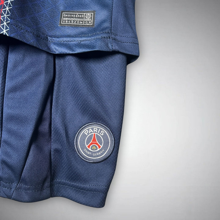 Kids PSG home kit 2025-26 featuring breathable fabric and iconic team logo for young fans