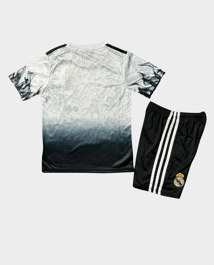 Kids Real Madrid jersey 2025 with black and red stripes, featuring comfortable shorts for young fans