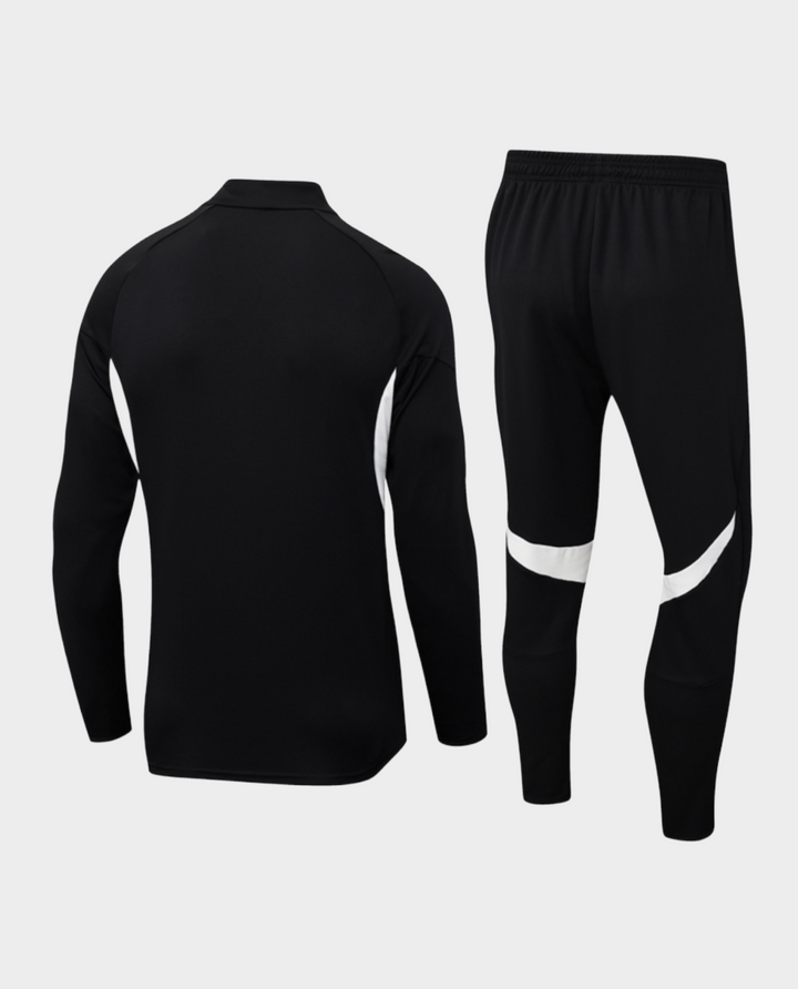 Striker Store Liverpool training suit 2025-26 in black with white accents, featuring a zip-up top and fitted pants