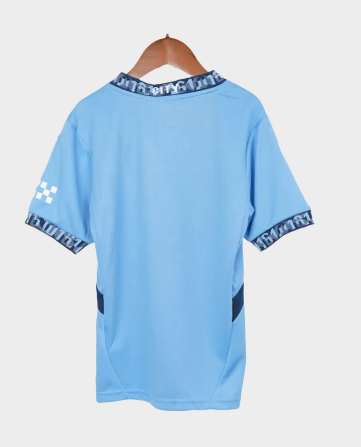 Back view of Kids Manchester City Home Jersey 2024 in sky blue with patterned collar and cuffs