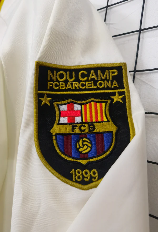 Barcelona windbreaker jacket 2025-26 featuring the Nou Camp embroidered logo on the sleeve