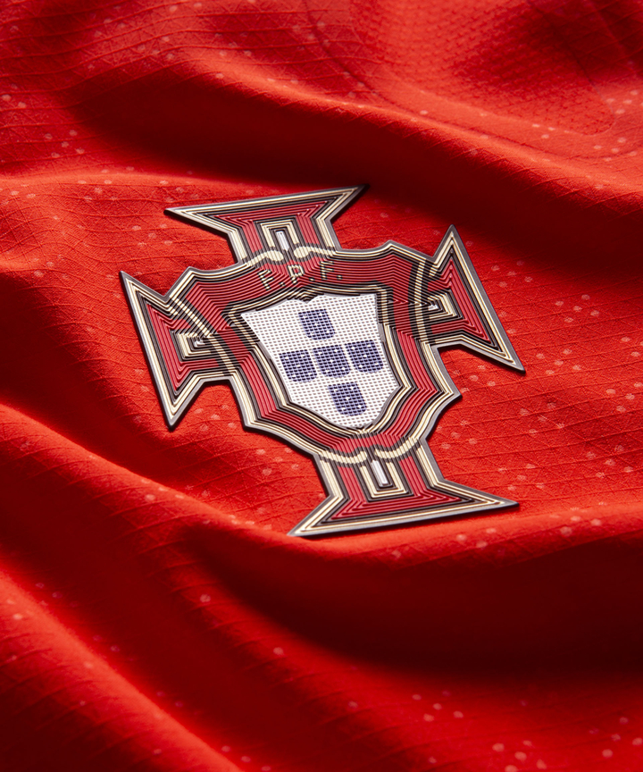 Close-up of Portugal home jersey 2024 showing the embroidered emblem on vibrant red fabric