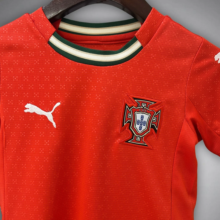 Kids Portugal football kit 2025-26 featuring the team's crest and Puma logo on a vibrant red jersey