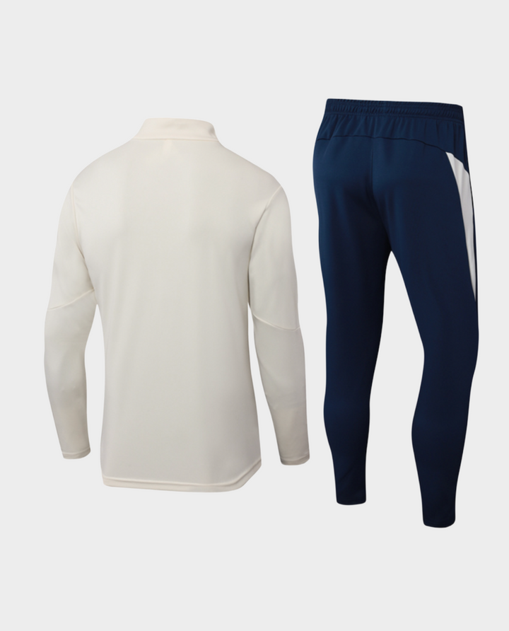 Striker Store Portugal training suit cream 2025-26 featuring a cream top and navy pants