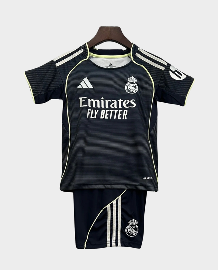 Kids Real Madrid away kit 2025-26 featuring a black jersey and shorts with Emirates logo