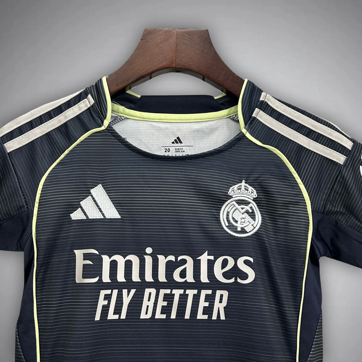 Kids Real Madrid away kit 2025-26 featuring dark design and iconic team logo for young fans