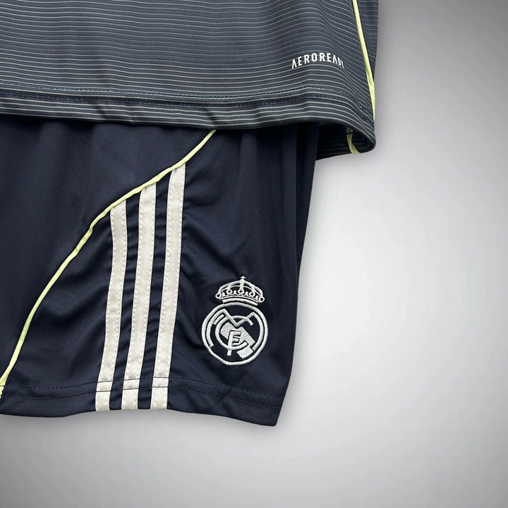Kids Real Madrid away kit 2025-26 featuring navy shorts and shirt with team logo and stylish design